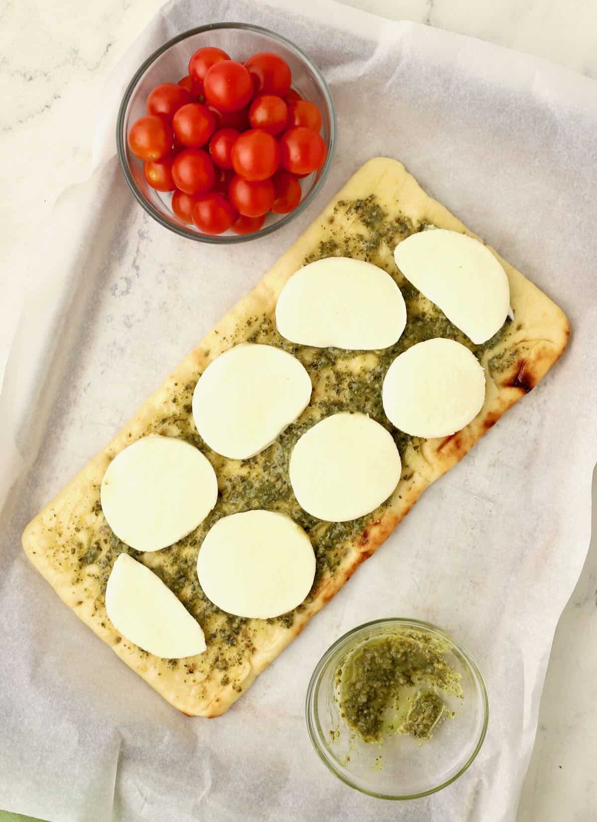 Flatbread topped with slices of fresh mozzarella cheese.