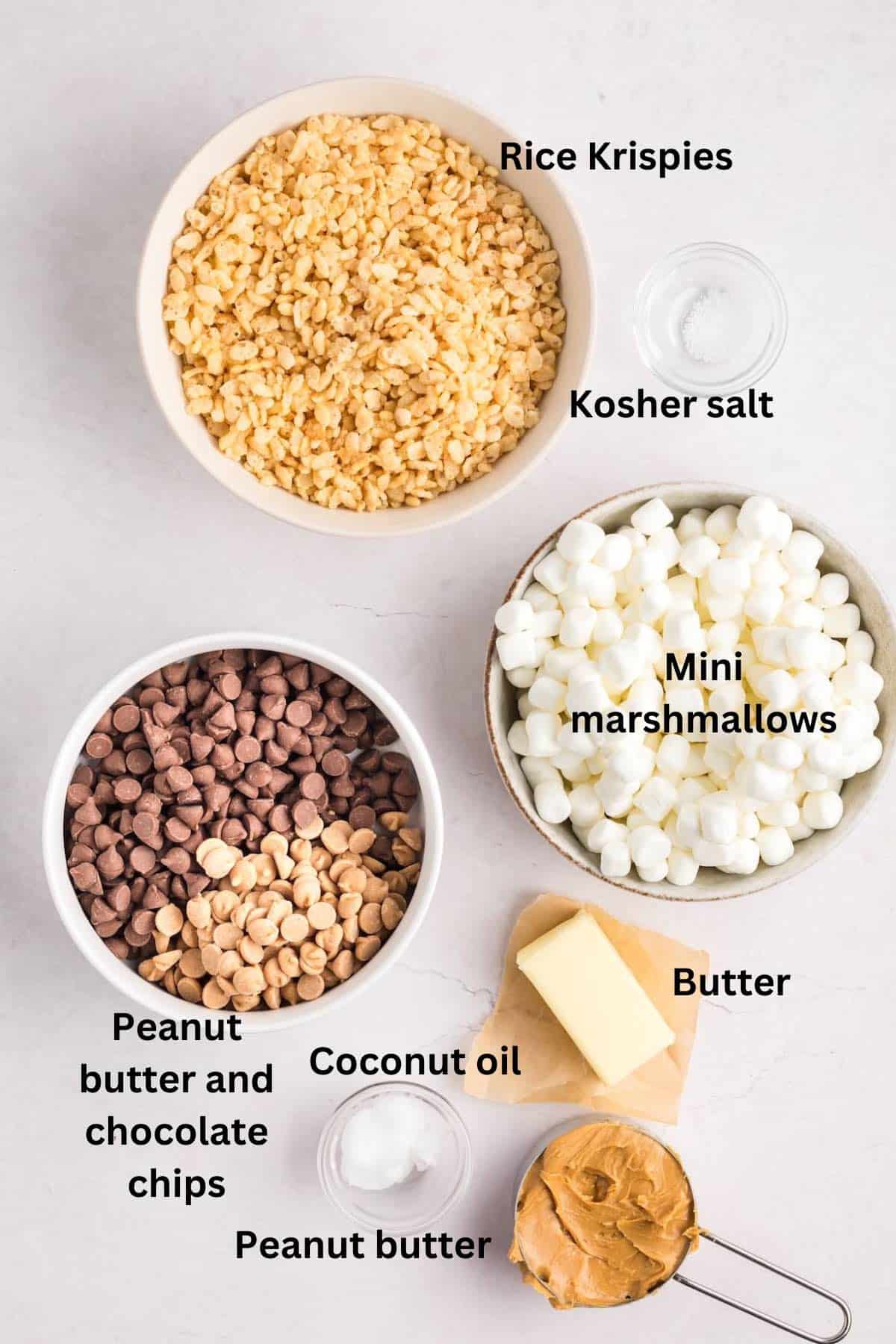 Ingredients to make peanut butter and chocolate rice krispy bars. include mini marshmallows and rice krispies. 