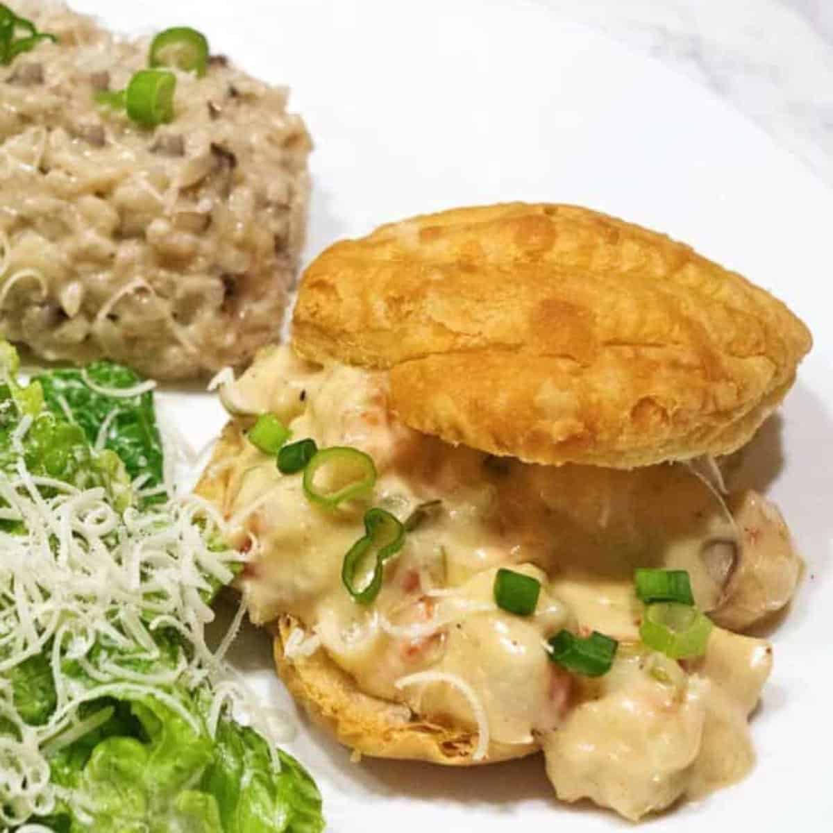 Shrimp Newburg in a puff pastry shell on a dinner plate. 