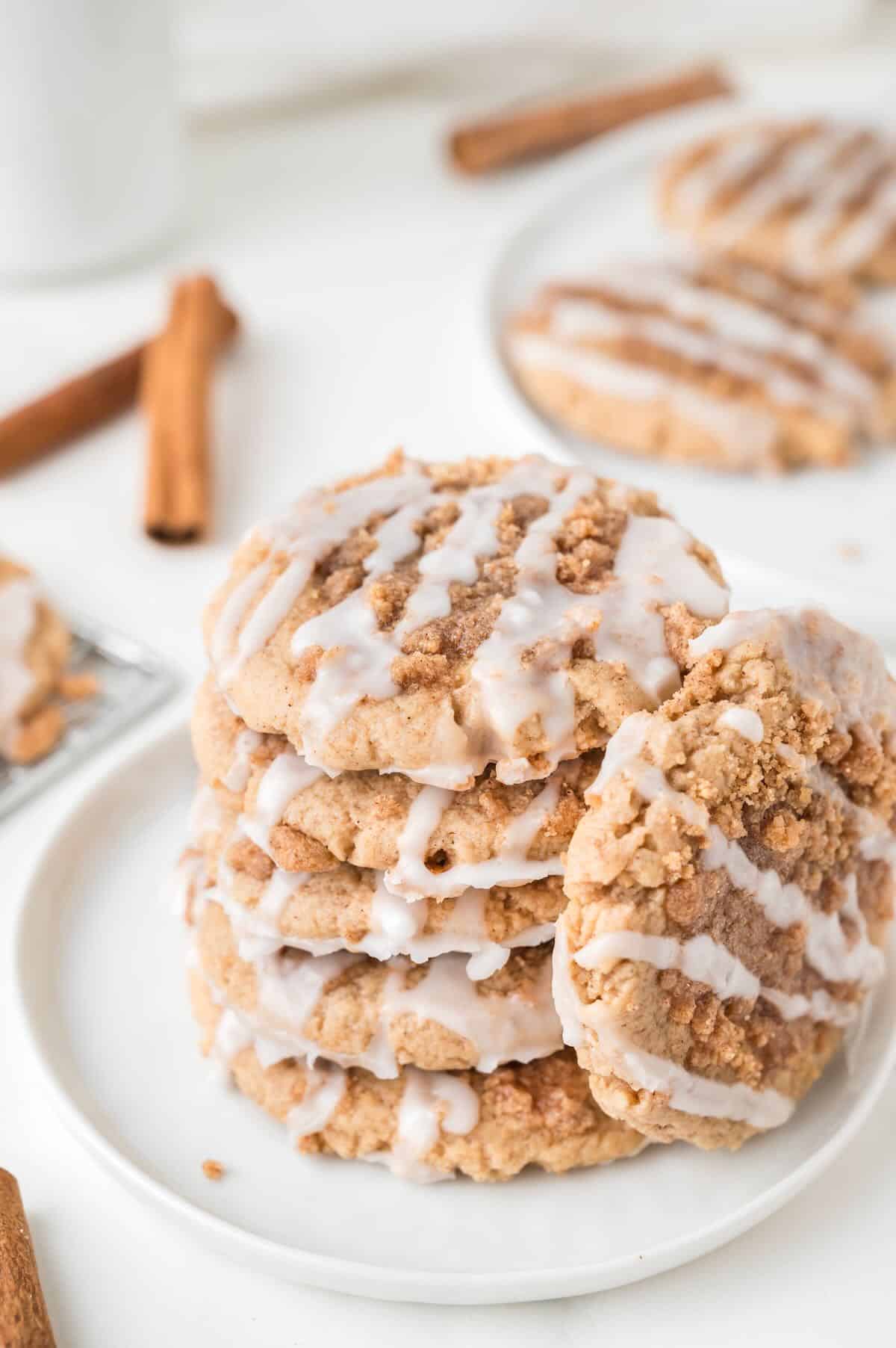 A stack of coffee cake cookies topped with icing on a plate.