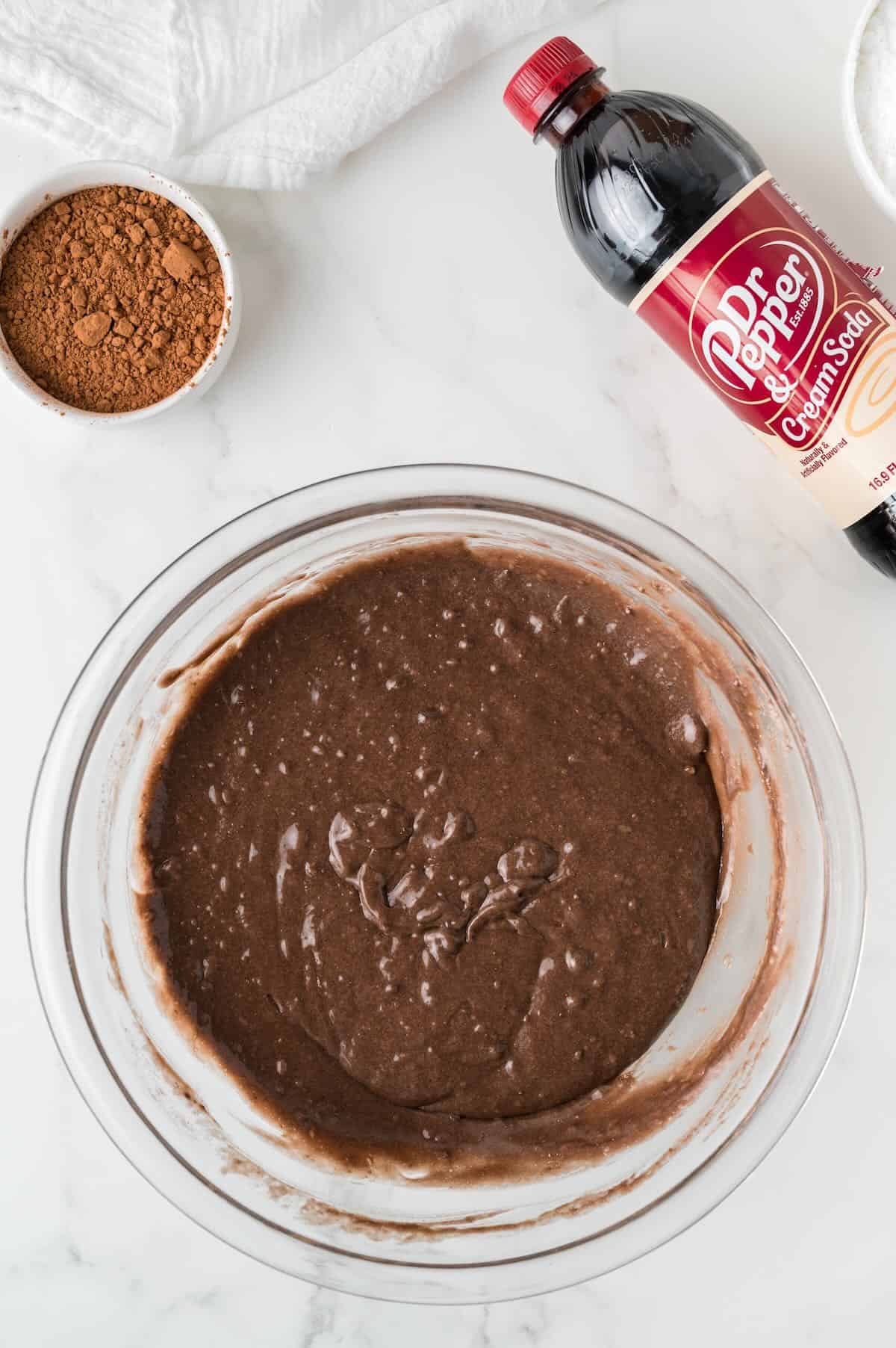 Chocolate cake batter in a clear glass bowl. 