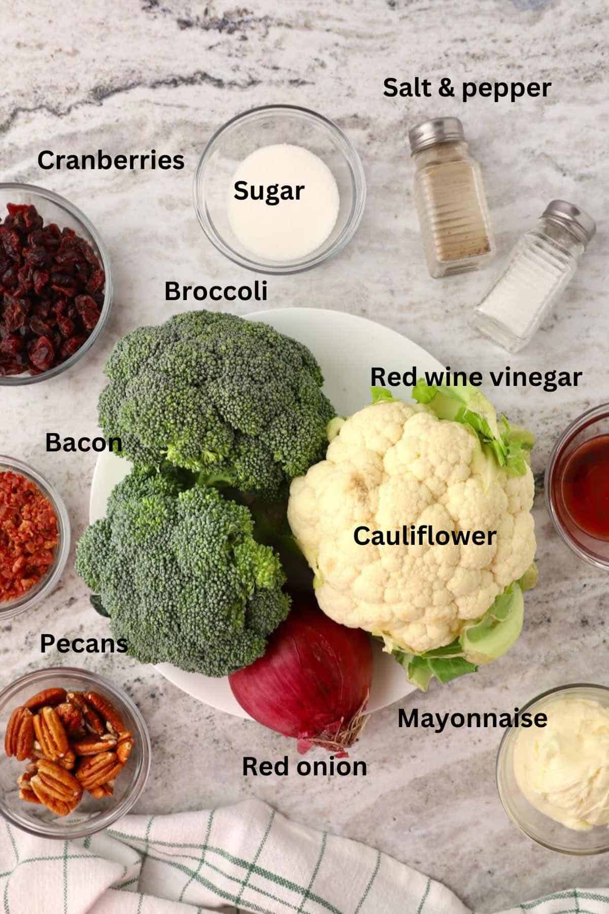 Broccoli cauliflower salad ingredients include cranberries and bacon. 
