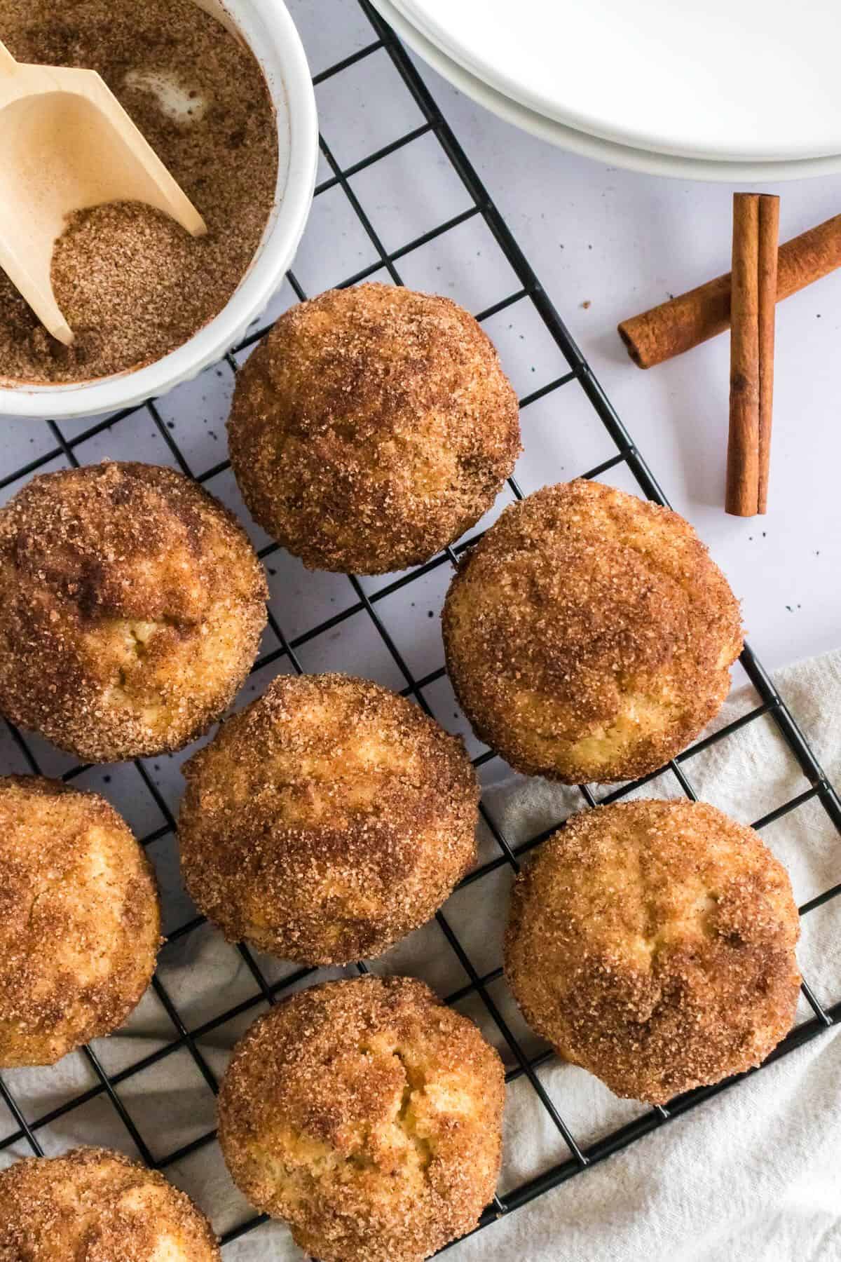 A wire cooling rack with cinnamon muffins just out of the oven. 