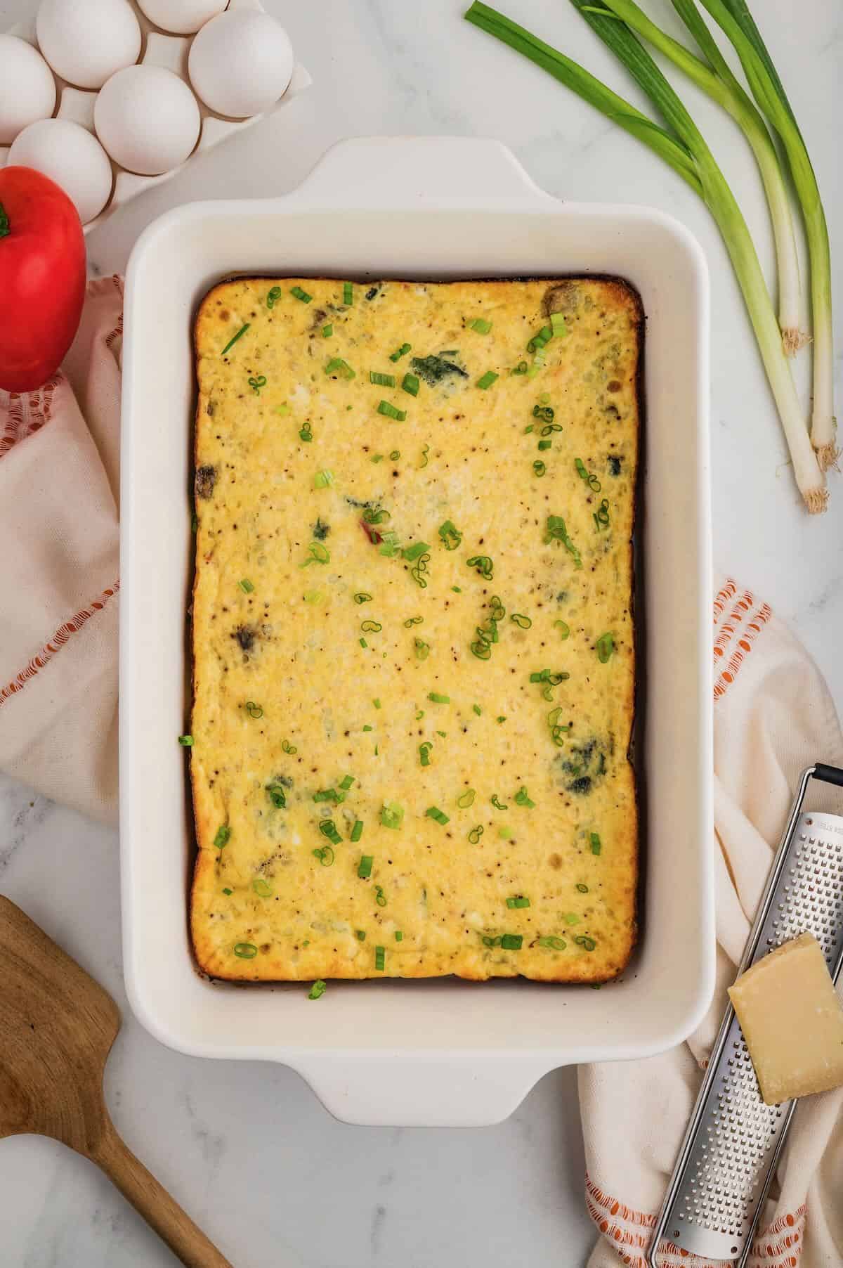 Baked cottage cheese egg bake in a white rectangle baking dish. 