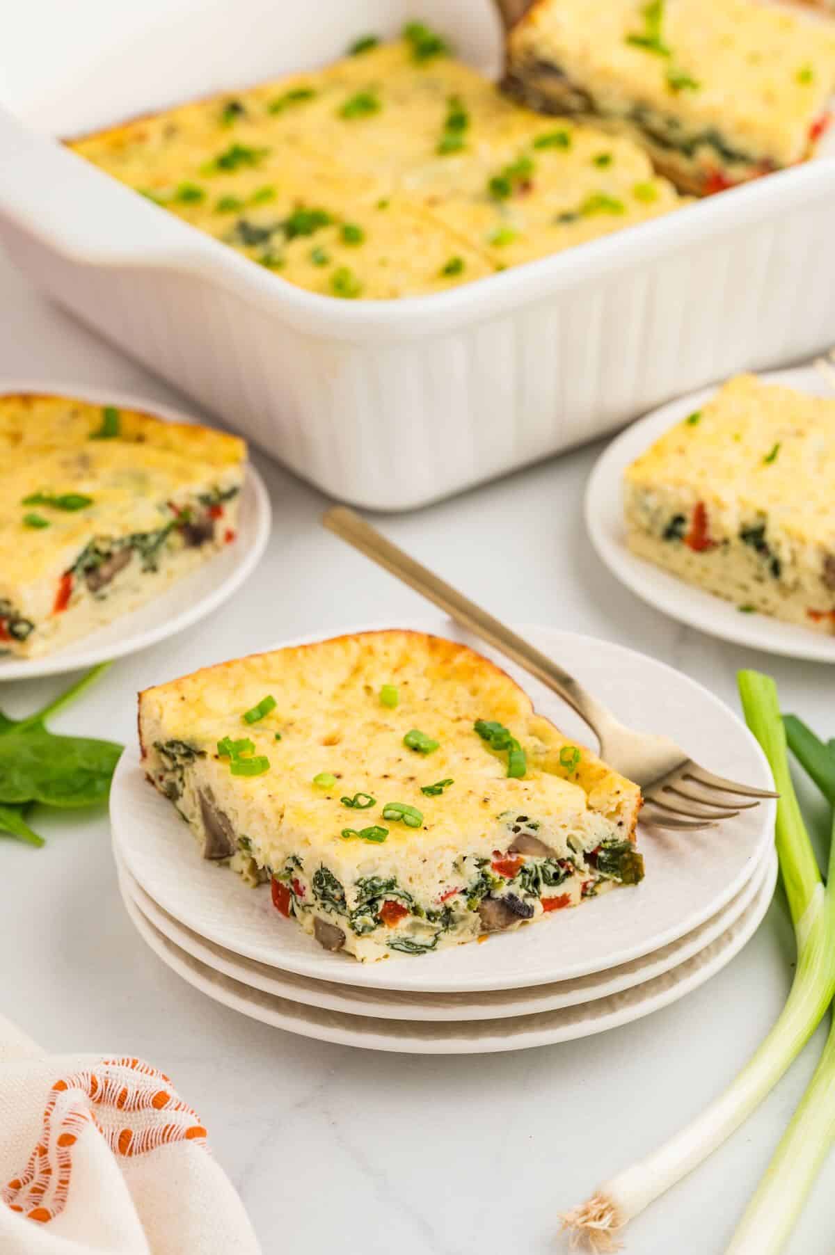 A slice of cottage cheese egg bake on a white plate. 