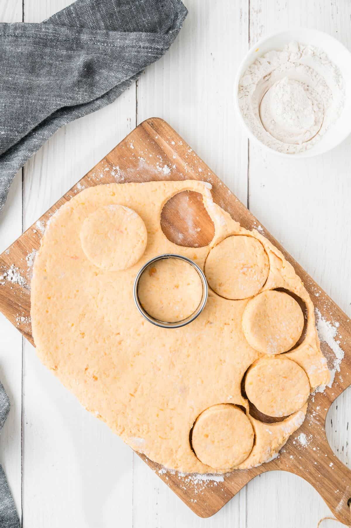 Biscuit dough rolled out and cut into rounds with a biscuit cutter. 