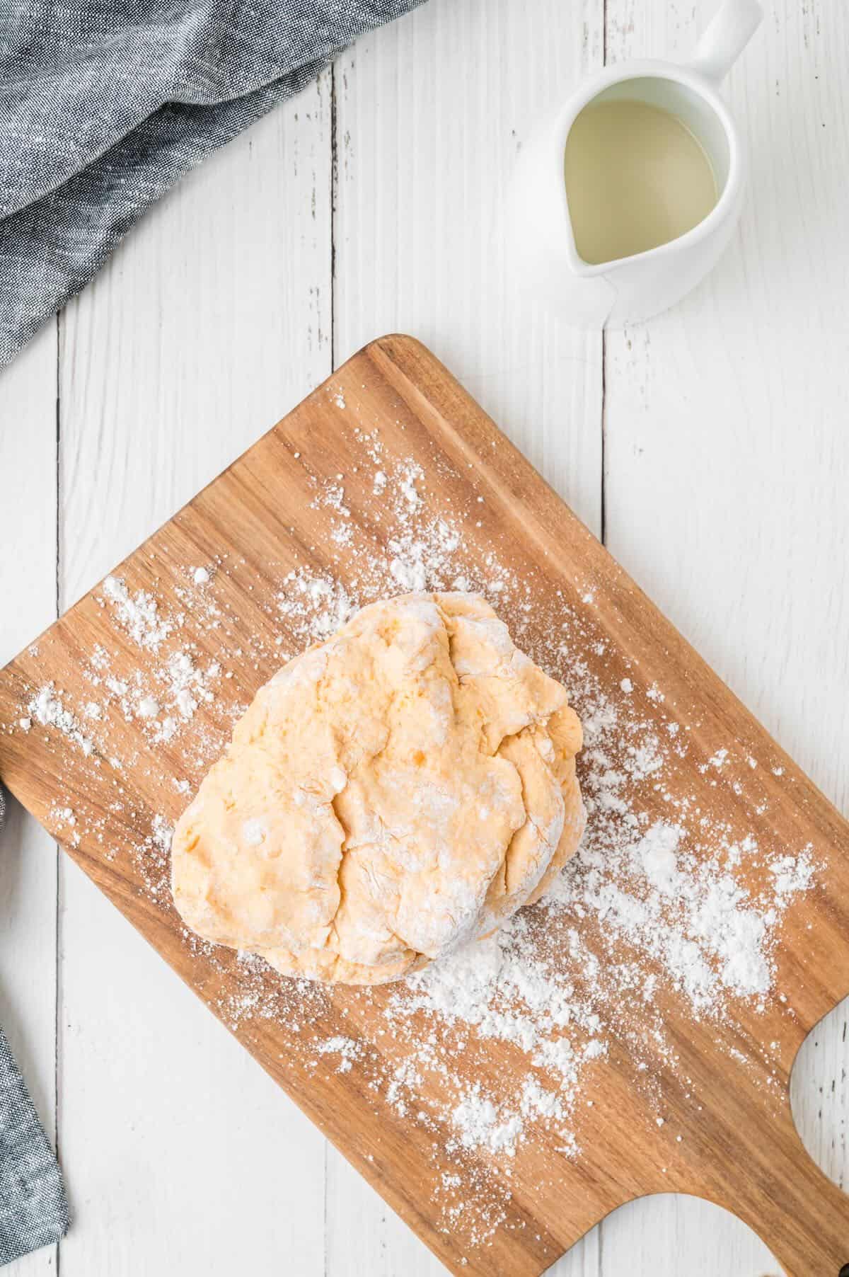 Biscuit dough on a floured cutting board. 