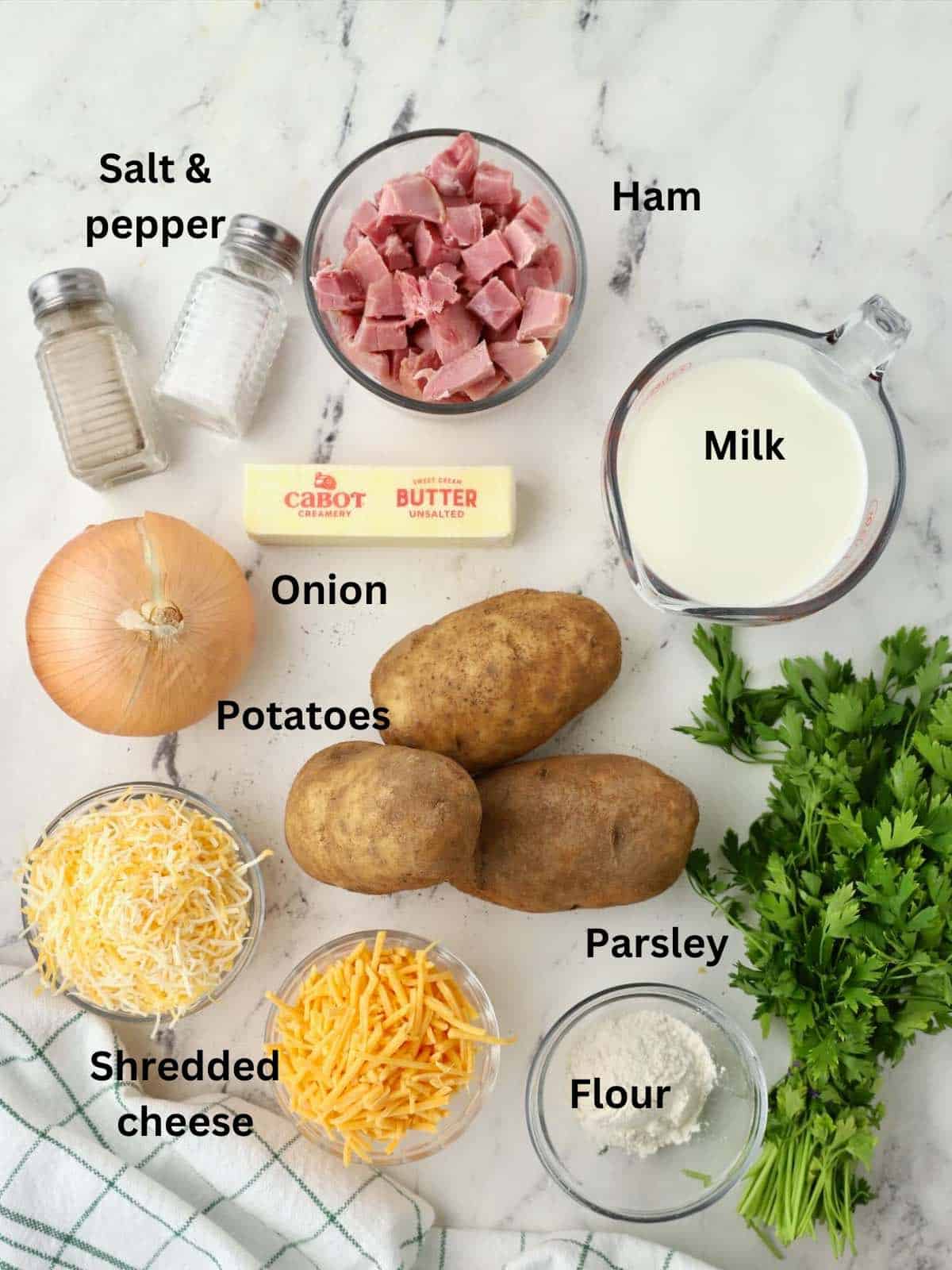 Ingredients to make ham and scalloped potatoes include, ham, potatoes, cheese, milk and flour.