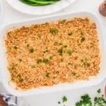 Million Dollar Chicken Casserole topped with Ritz Cracker crumbs in a white baking dish.