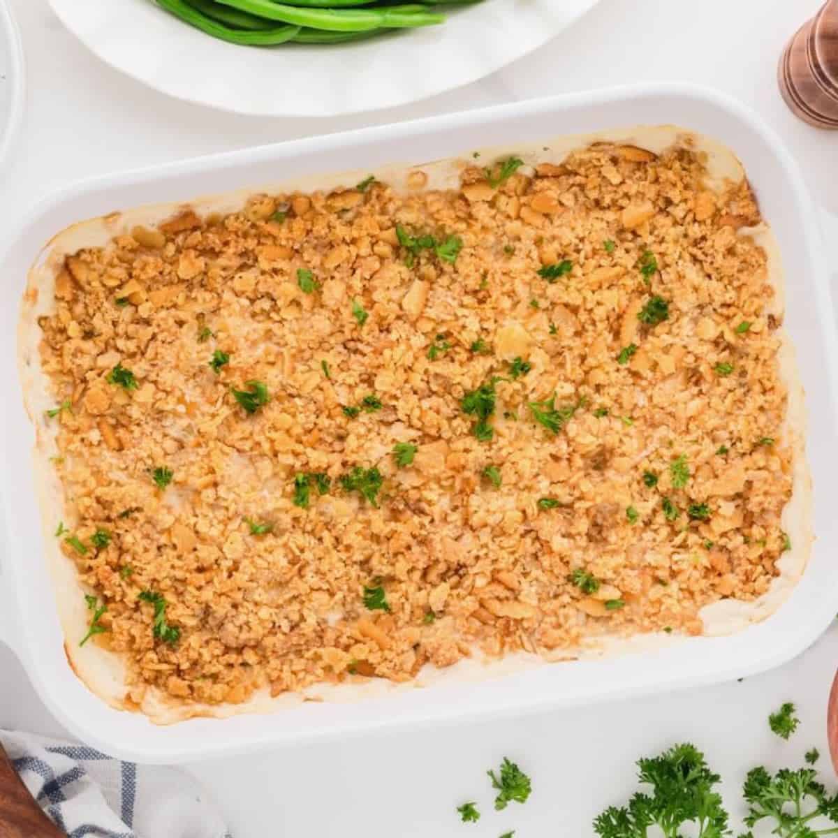 Million Dollar Chicken Casserole topped with Ritz Cracker crumbs in a white baking dish.