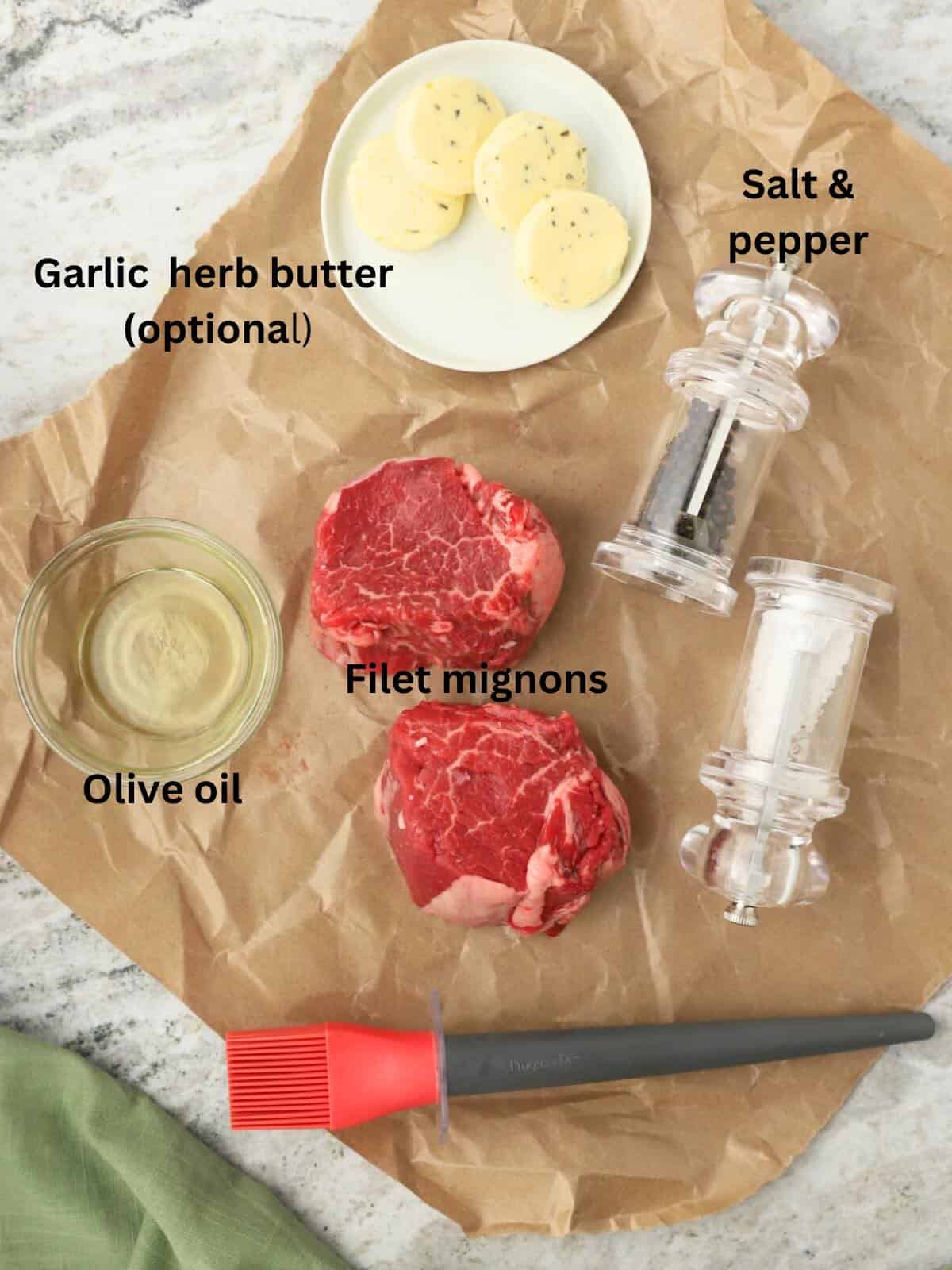Two raw filet mignons, plus butter, salt and pepper, and olive oil.