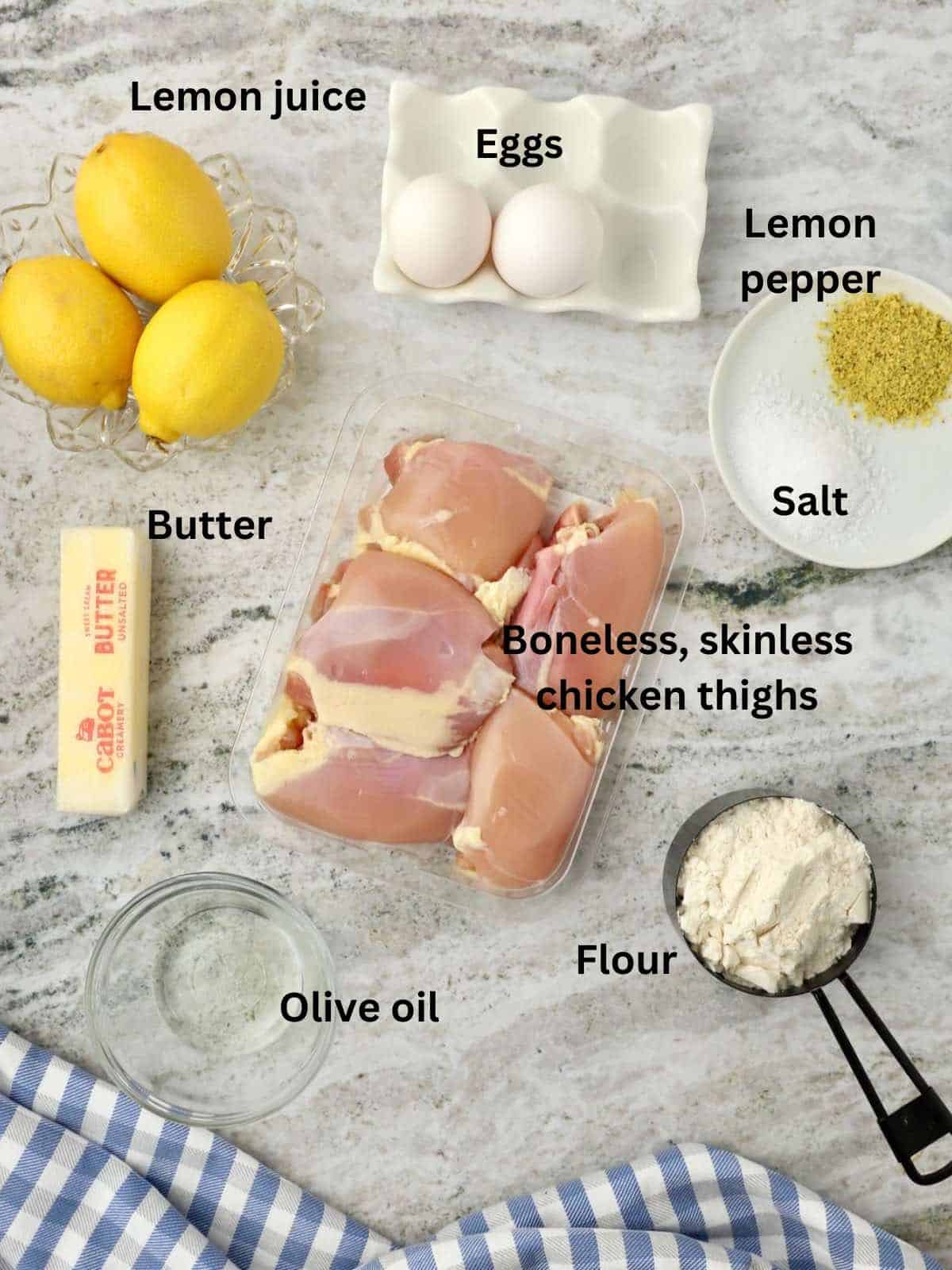 Ingredients to make a dish with chicken thighs including flour, oil, butter, and seasonings. 