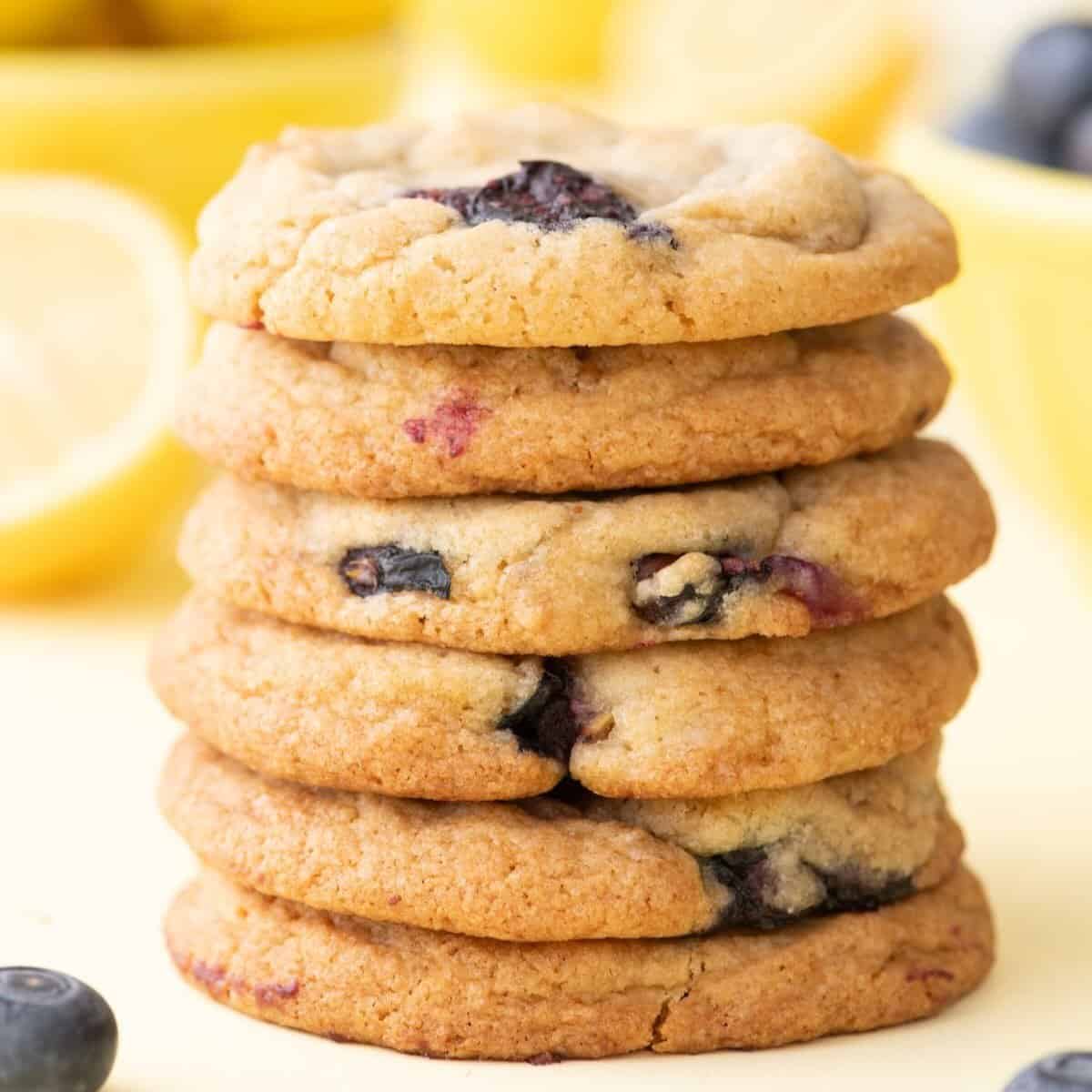 A stack of six lemon blueberry cookies on a plate.