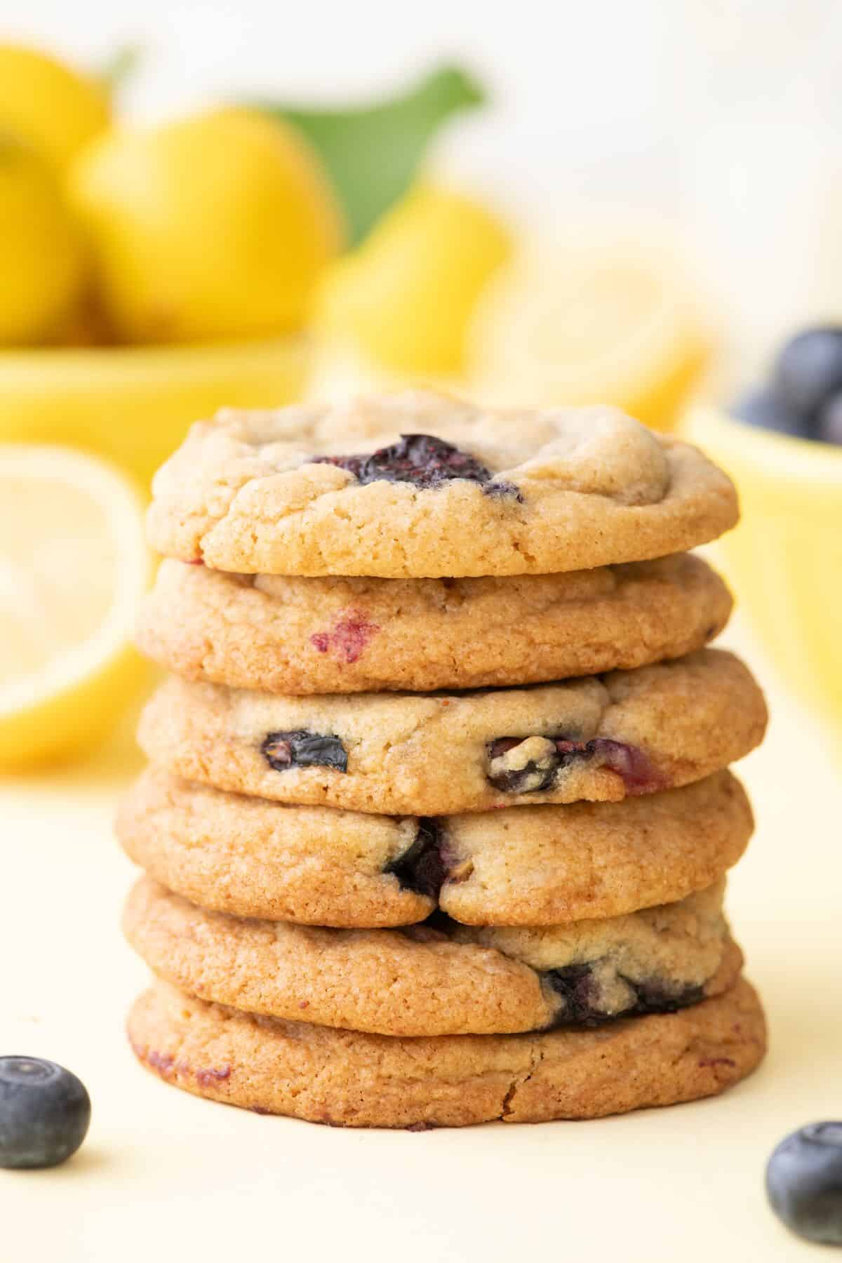 A stack of six lemon blueberry cookies on a plate. 