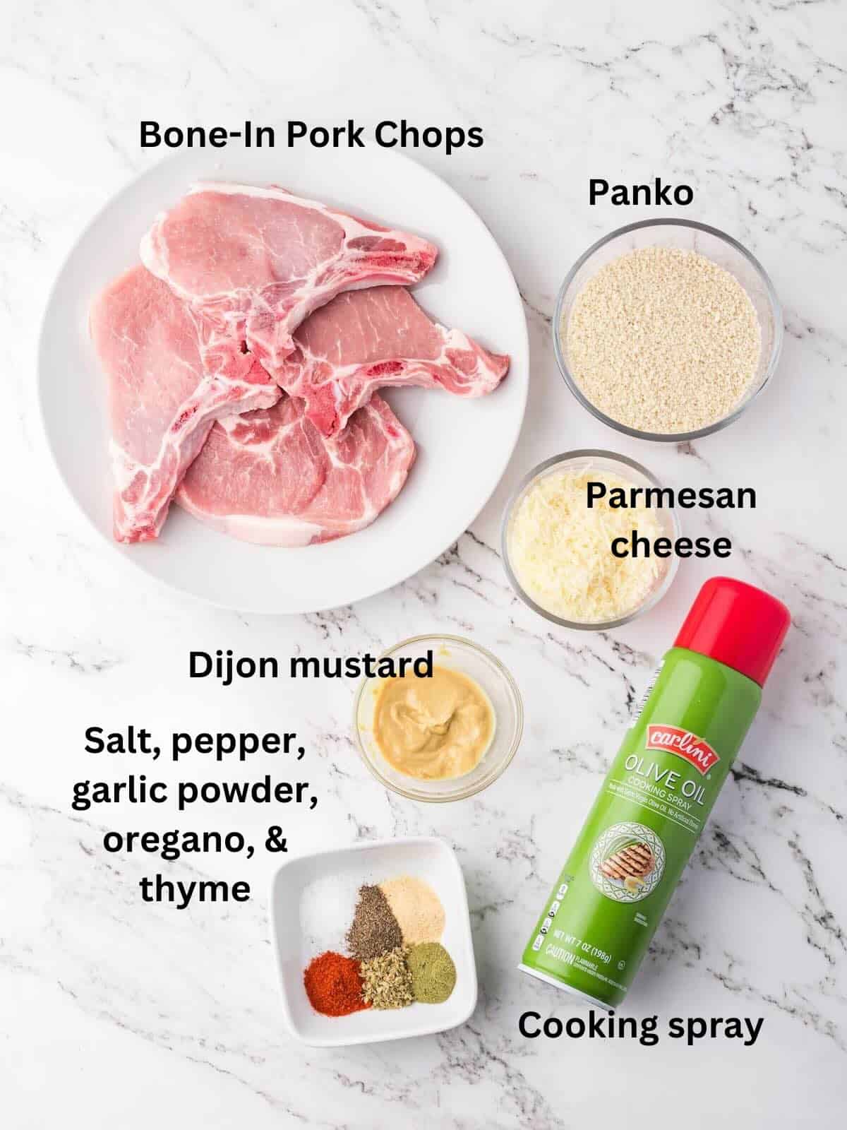 Ingredients for breaded air fryer pork chops, includes pork chops, seasonings, Dijon mustard, and panko.
