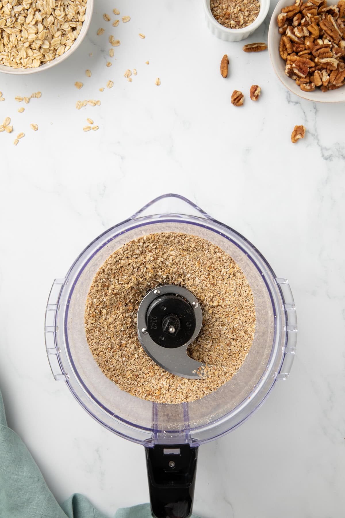 Toasted oats are processed in a food processor until they turn into oat flour. 