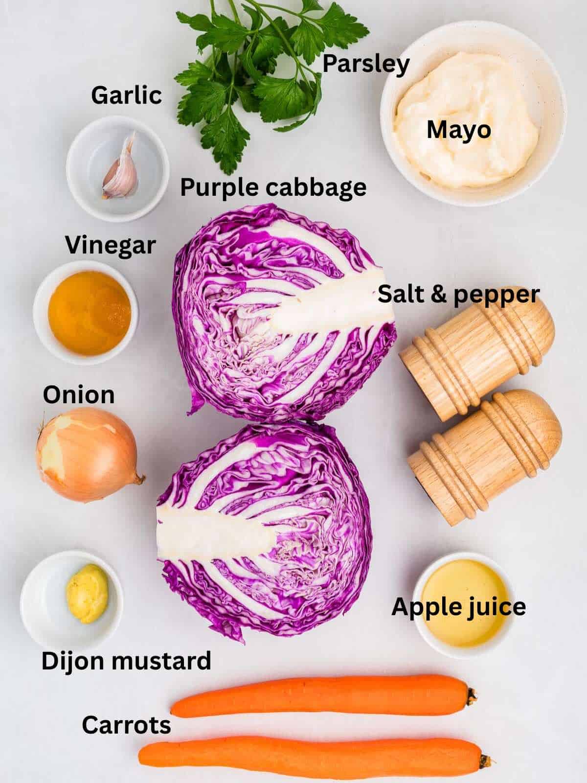 Ingredients to make purple cabbage coleslaw include red or purple cabbage, carrots, onion, and garlic, plus dressing ingredients.
