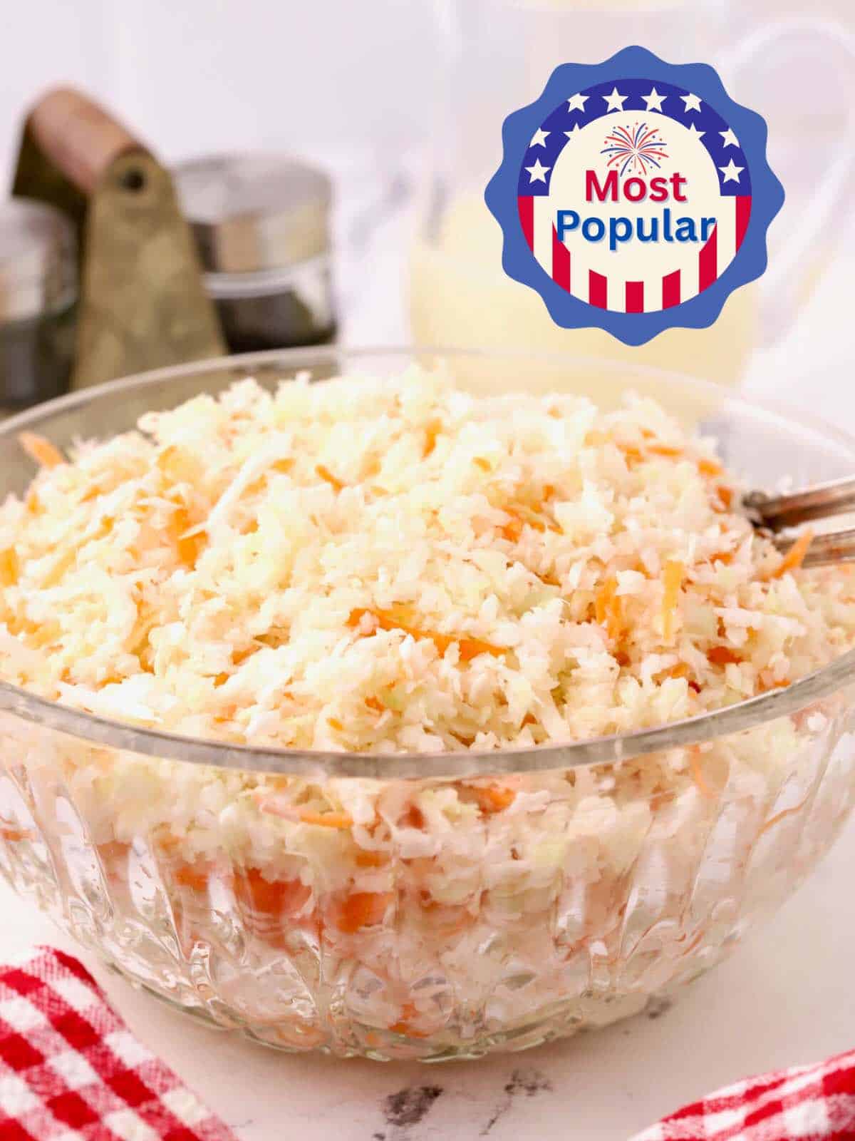 A large bowl of American Coleslaw containing shredded green cabbage and carrots.