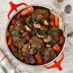 Braised chuck roast with carrots and mushrooms cooked in a red wine sauce.