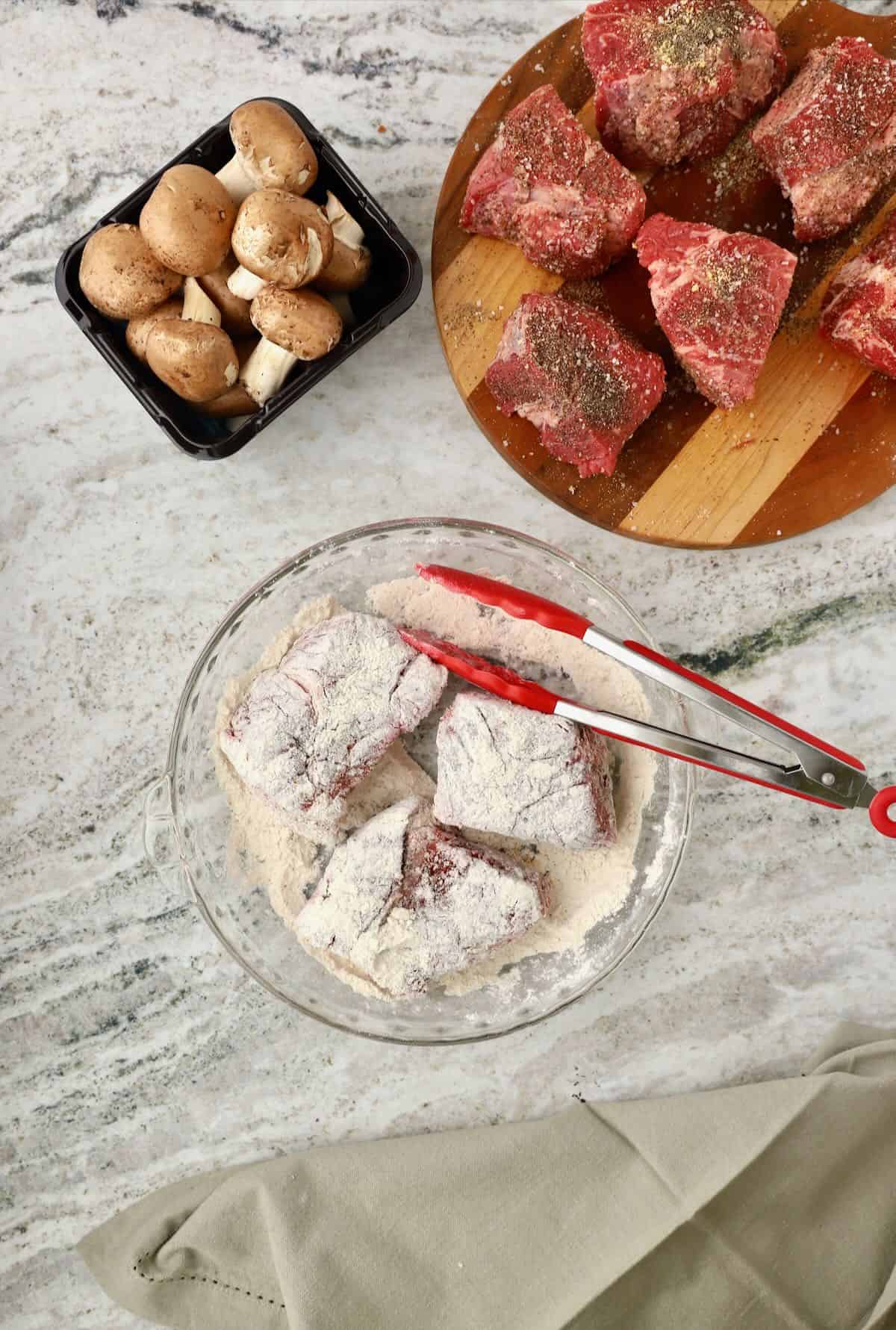 Chuck roast cut into cubes and coated in flour and seasonings. 