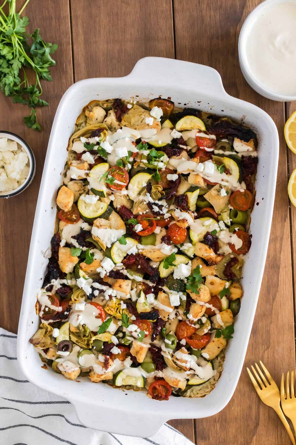 Mediterranean rice casserole topped with a drizzle of tahini sauce.  