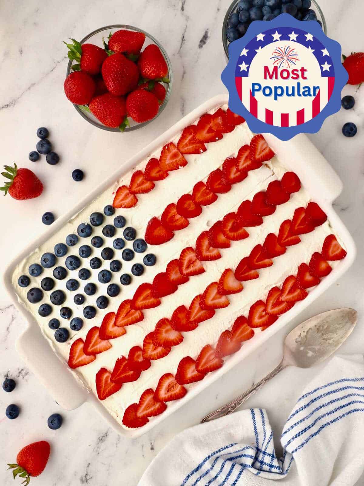 Red, white and blue icebox cake with sliced strawberries for the stripes and blueberries for the stars. 