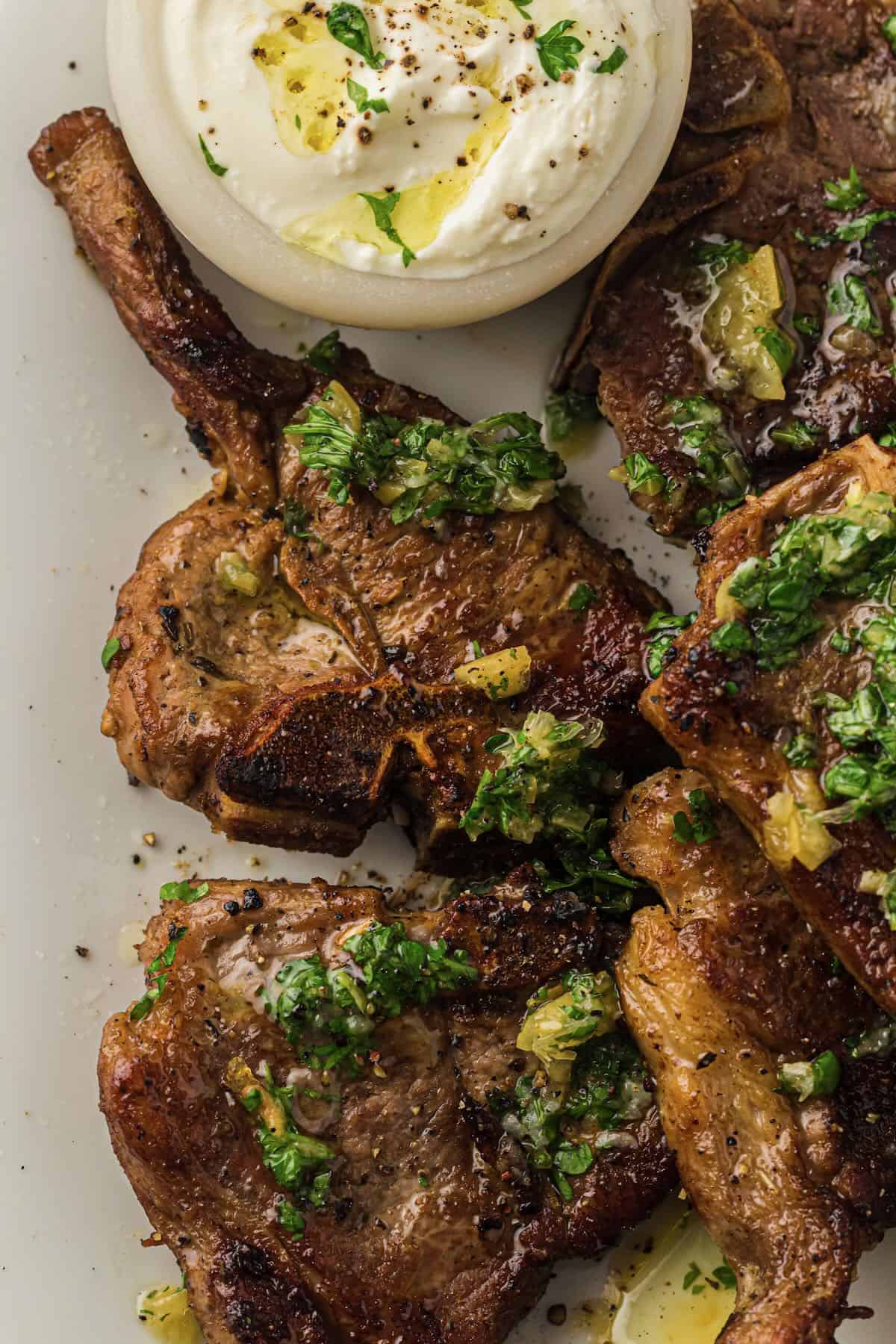 Pan seared lamb chops cooked in a cast iron skillet topped with gremolata