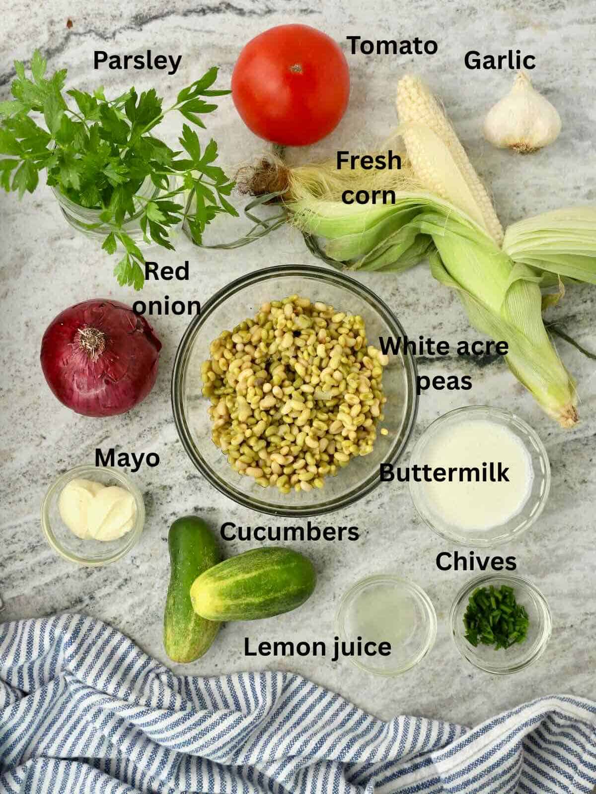 Ingredients for Southern pea salad include fresh corn, peas, tomatoes, cucumbers, and onions, plus buttermilk herb dressing ingredients. 