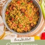 Pinterest pin showing Cajun Sausage and Rice garnished with sliced green onions in a skillet on a placemat, plus text