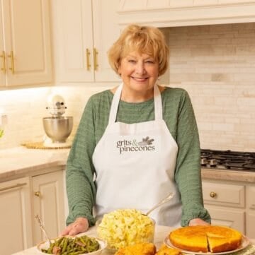 Grits and Pinecones blog founder, Sharon Rigsby in a white apron with a G&P logo.