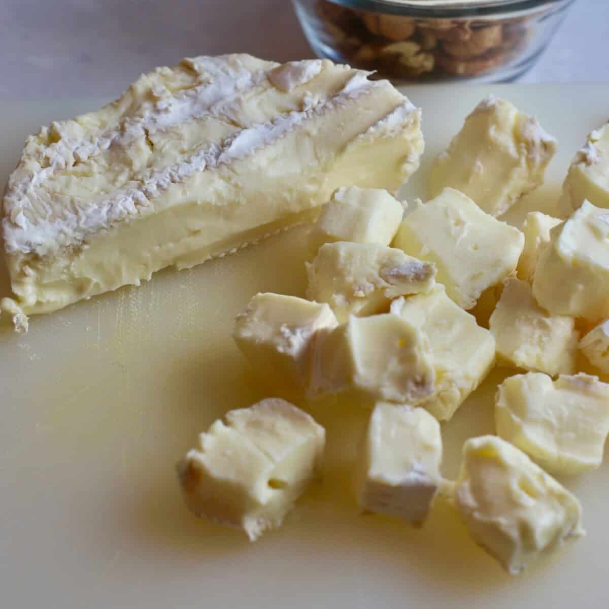 A round of brie cheese cut into cubes. 
