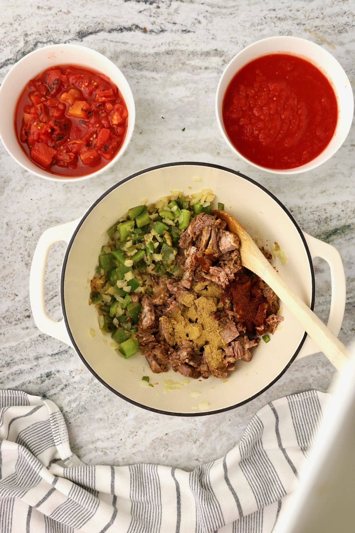 Chili powder, tomato paste and other seasonings are added. 