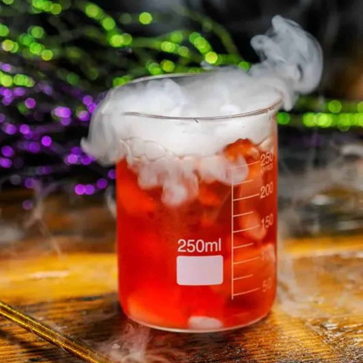 Poisoned apple cocktail in a science beaker with dry ice smoke. 