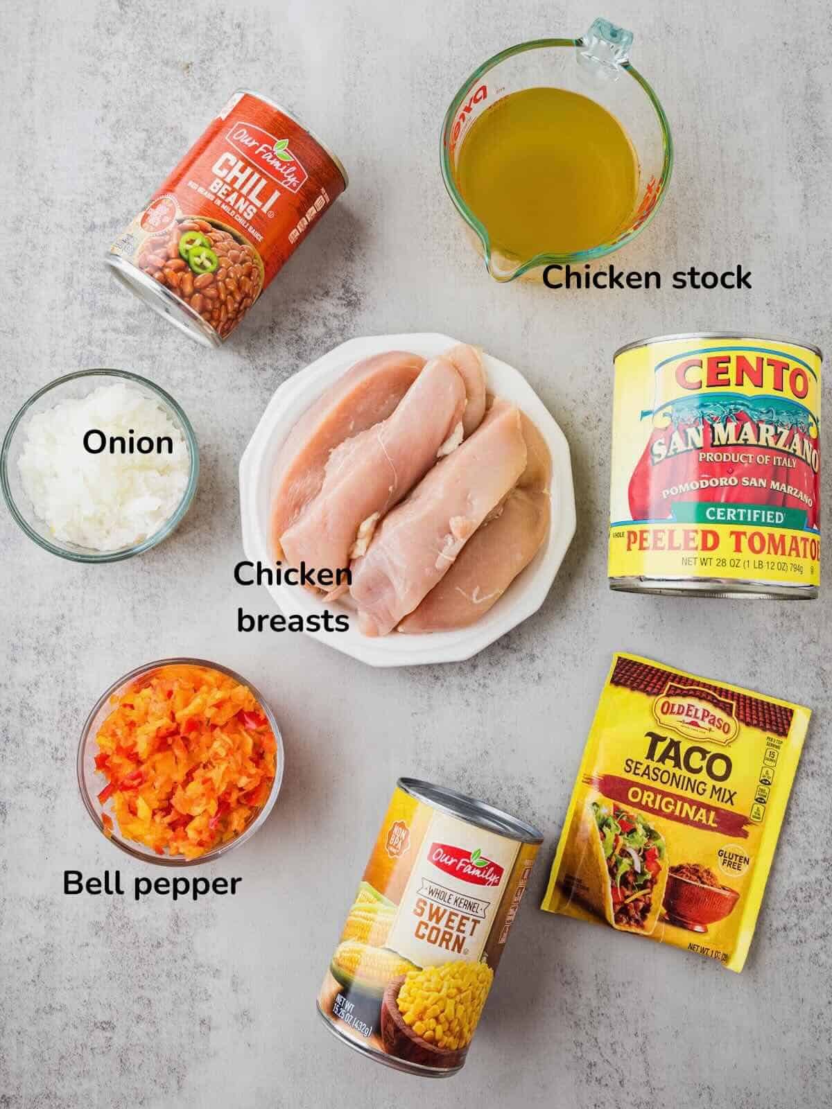 Ingredients for Chicken Taco Soup include, chicken breasts, canned tomatoes, corn and chili beans, as well as taco seasoning.
