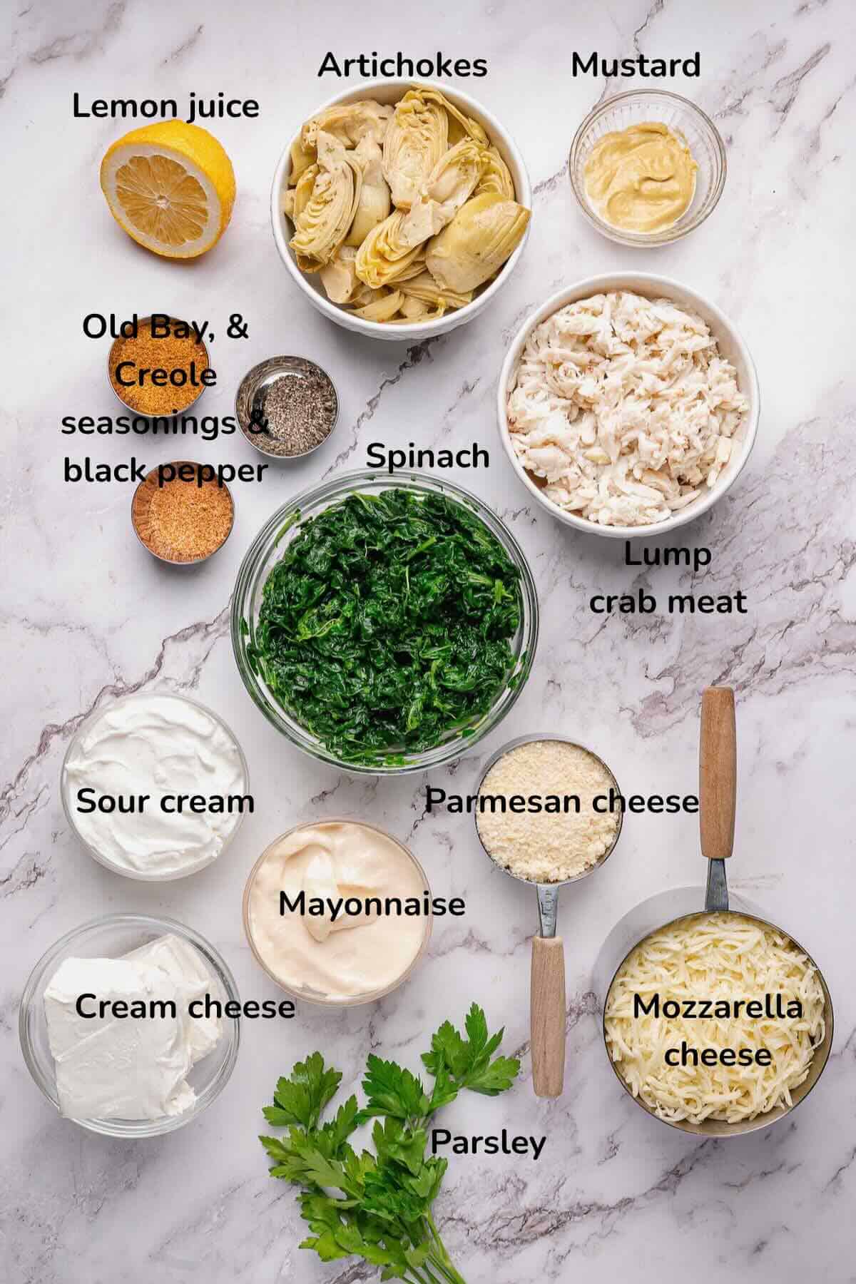 Ingredients for crab, spinach and artichoke dip include cream cheese, mozzarella cheese, mayonnaise, and sour cream along with crab and spinach. 