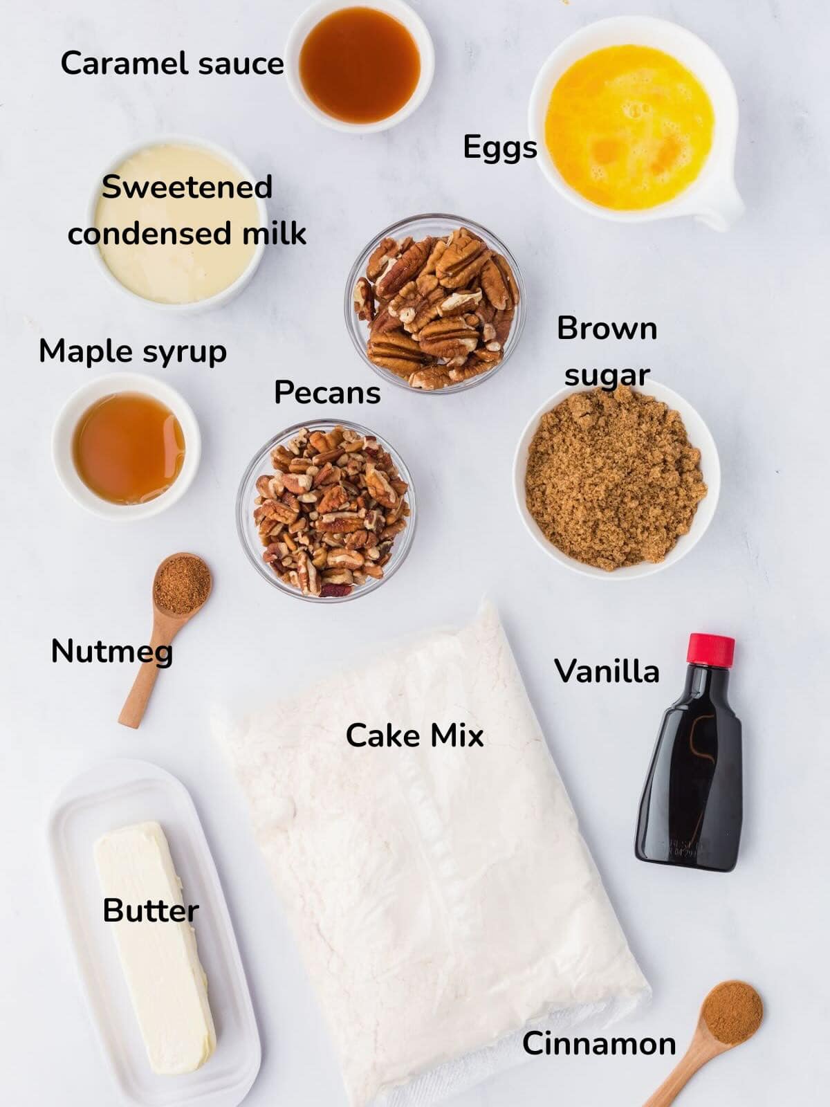 Ingredients for pecan pie dump cake include cake mix, brown sugar, sweetened condensed milk, and pecans. 