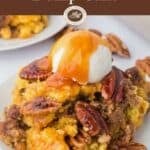 Pinterest pin with a serving of pecan pie dump cake on a plate topped with a scoop of ice cream and caramel sauce.