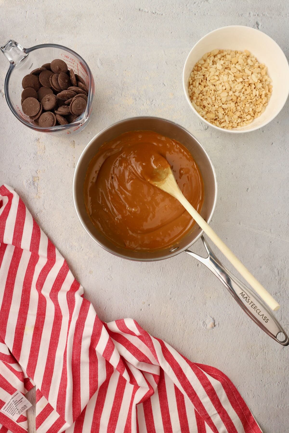 Caramel bits melting in a saucepan on the stove. 