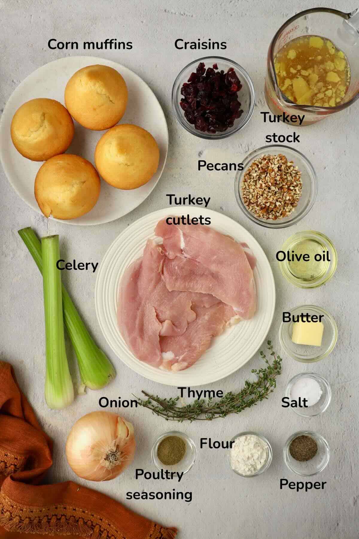 Ingredients to make pan seared turkey cutlets, cornbread dressing and pan gravy include turkey cutlets, celery, craisins, corn muffins and seasonings.