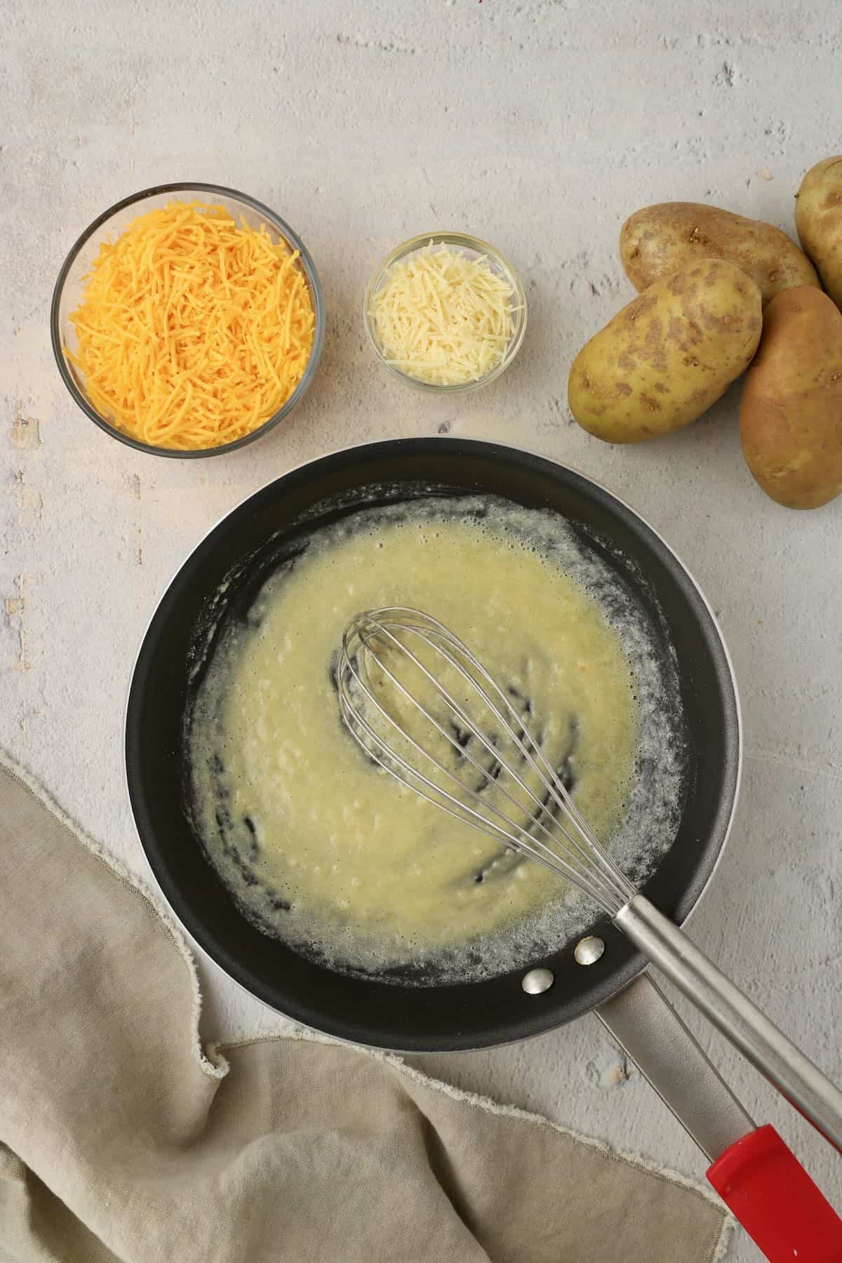 Flour and butter are cooking in a skillet.