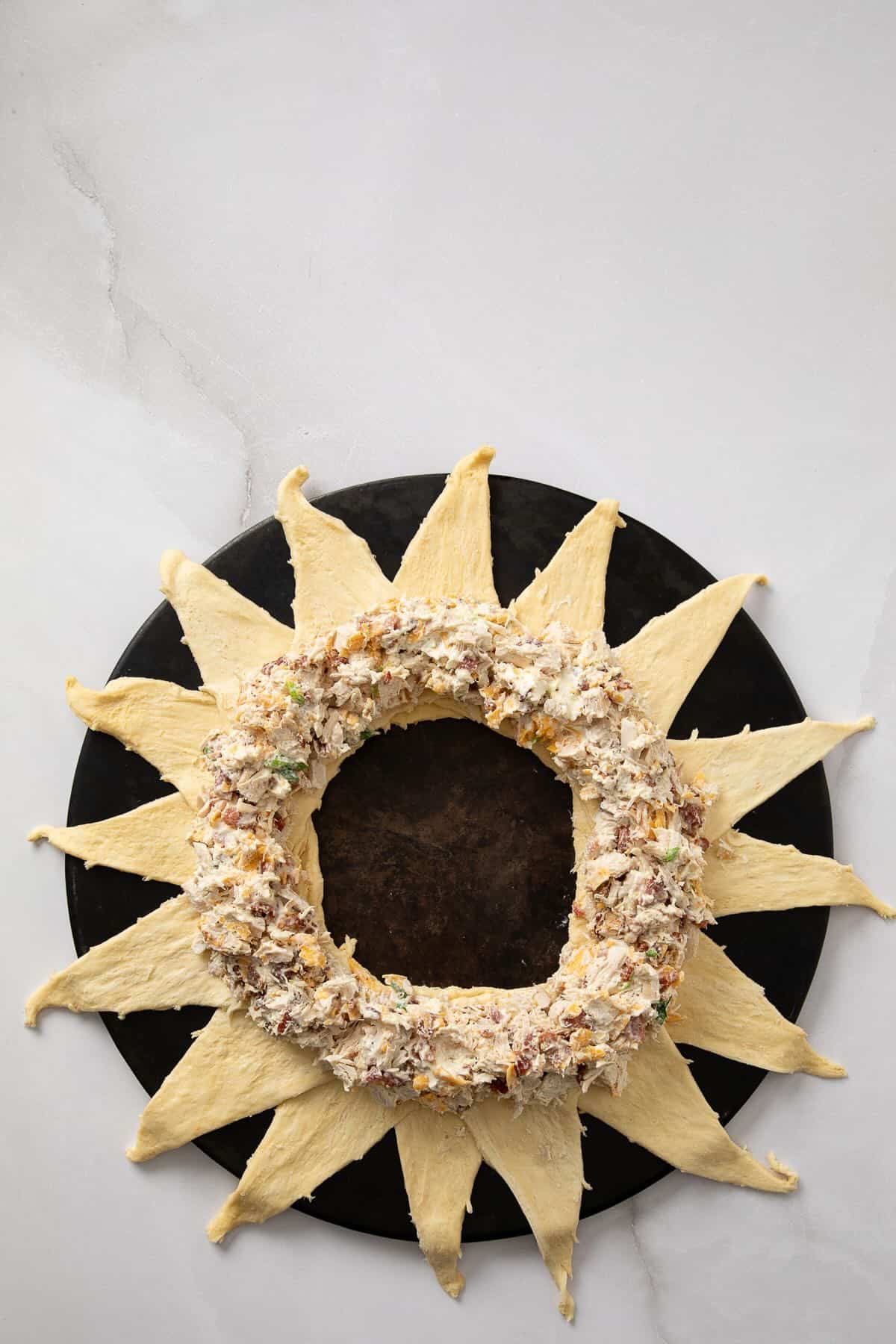 Chicken Bacon Ranch filling is spread out over the crescent roll dough.