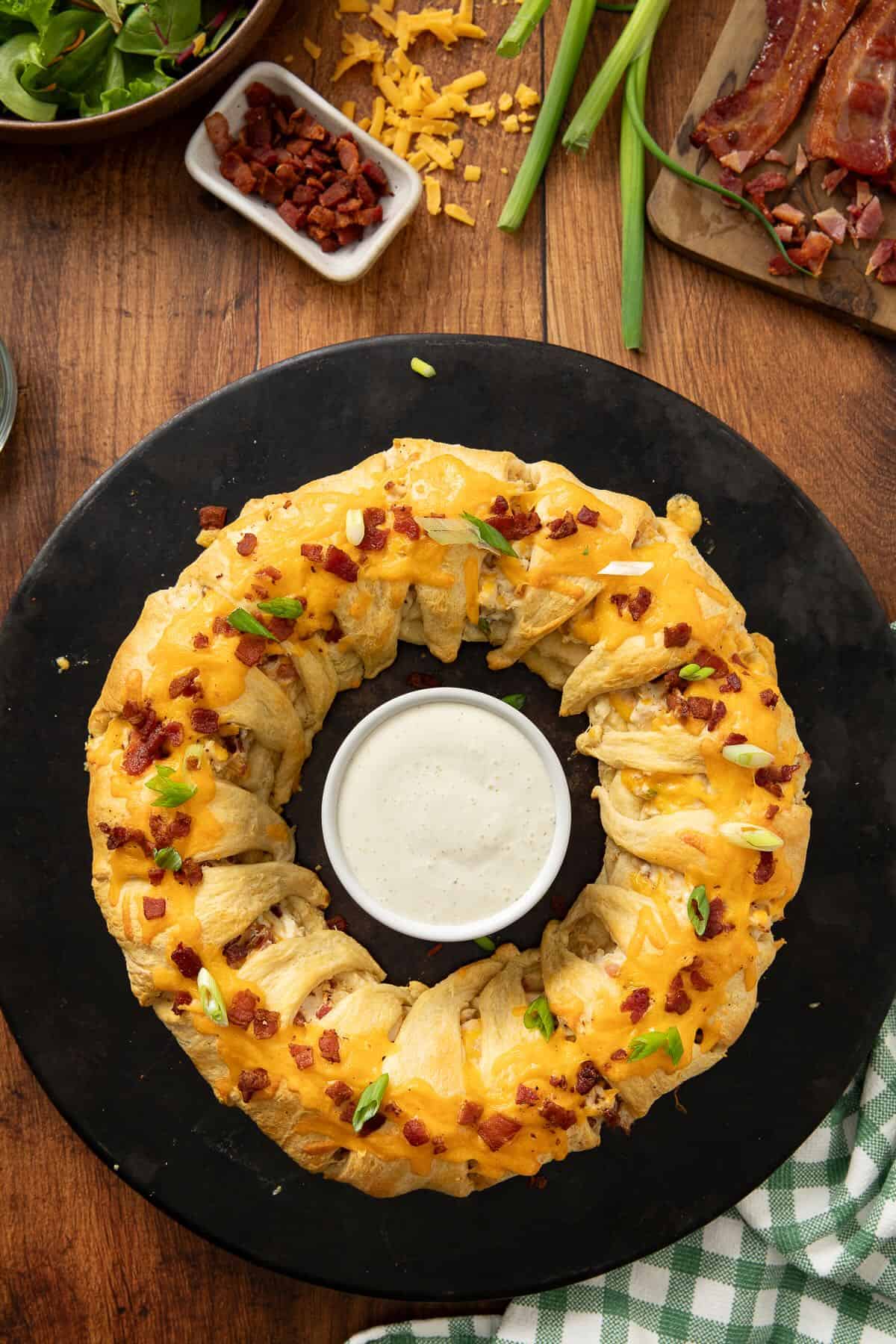 Baked Bacon Ranch Crescent Ring topped with melted cheddar cheese and bacon.
