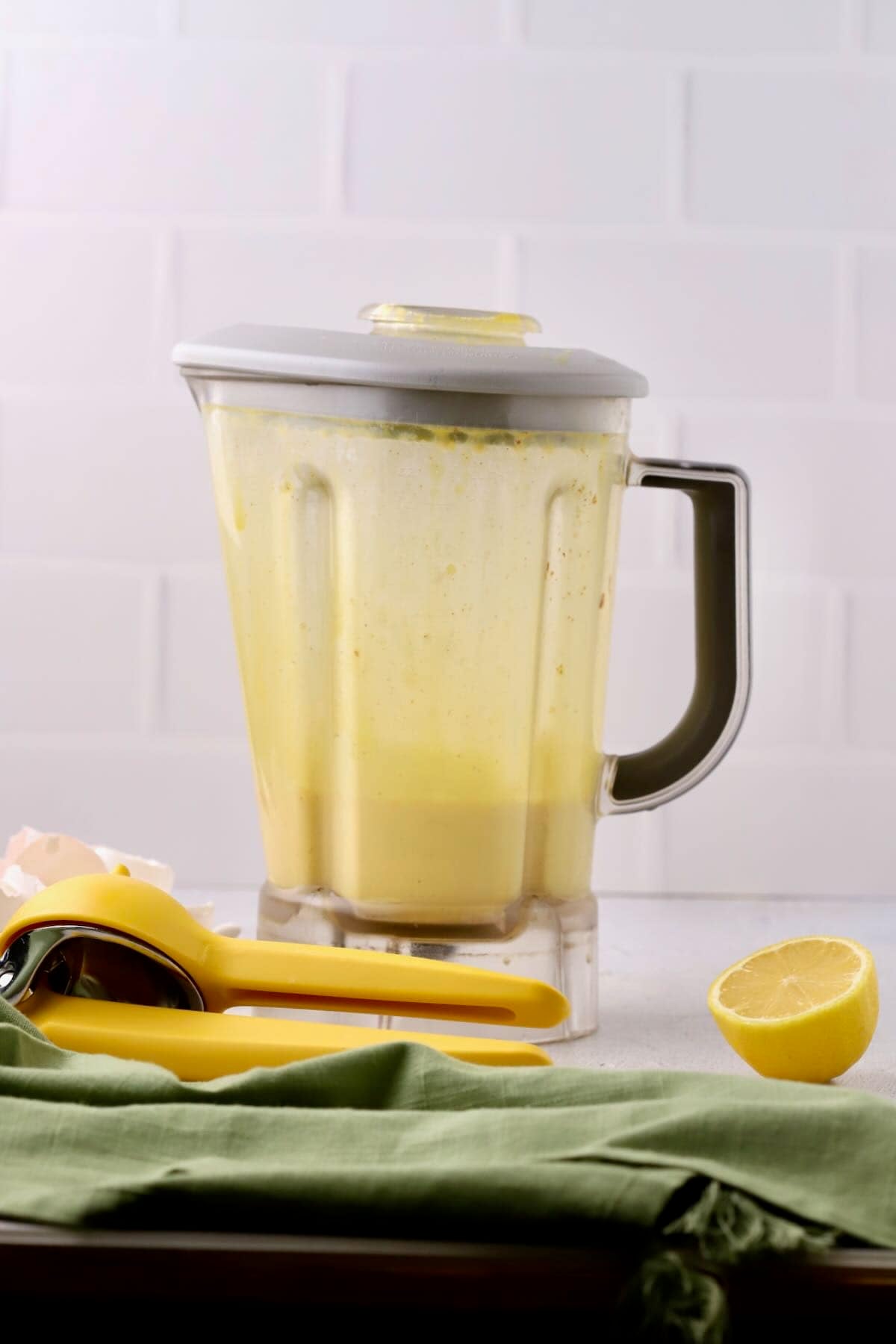 A blender jar filled with hollandaise sauce.