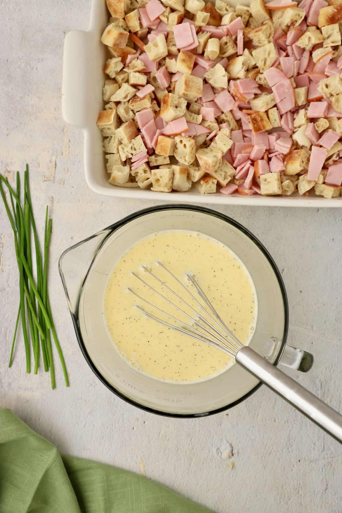 A large mixing bowl full of eggs, lemon juice and other ingredients for an egg custard.