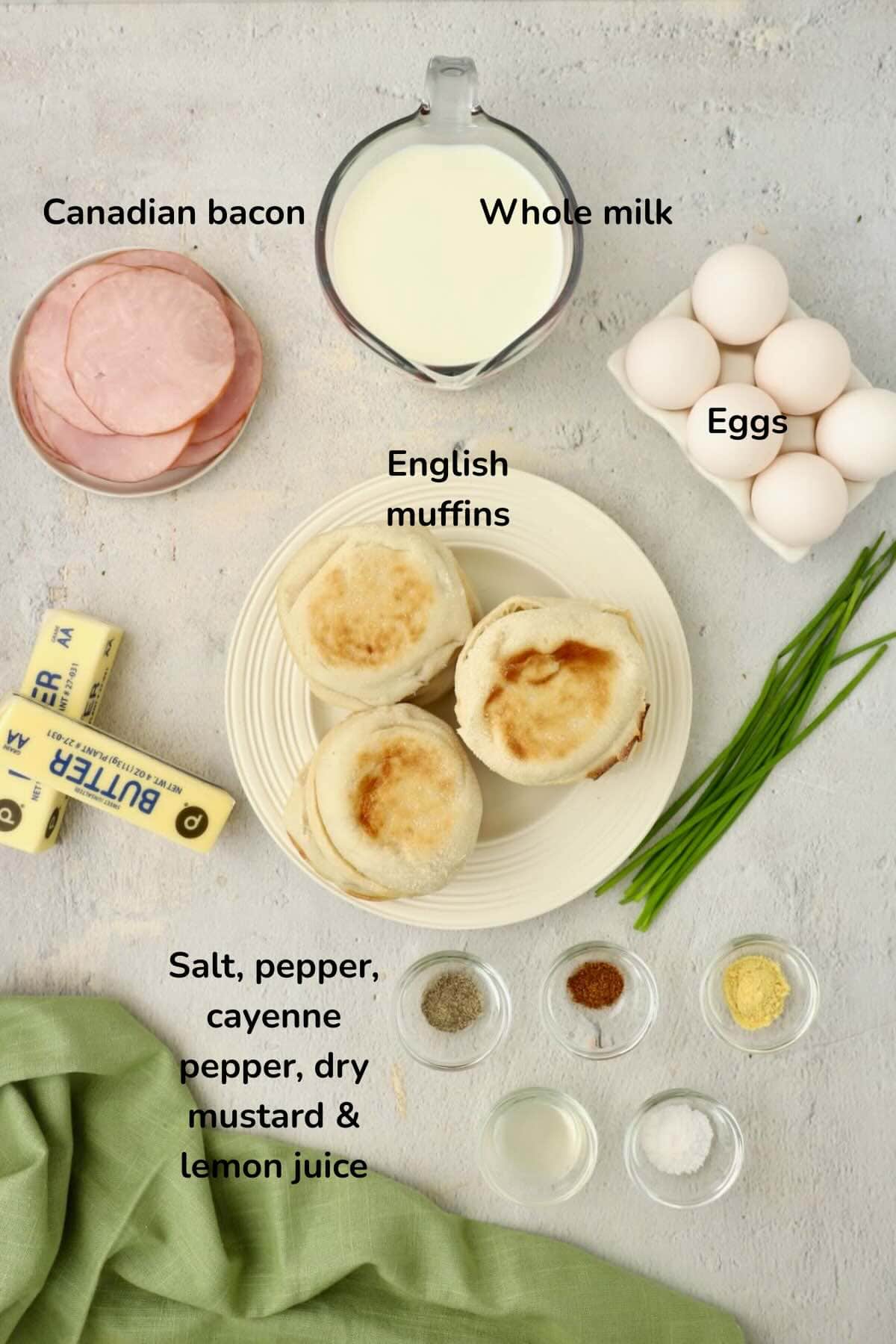 Ingredients for Eggs Benedict Casserole and Hollandaise sauce include eggs, butter, english muffins, and seasonings.