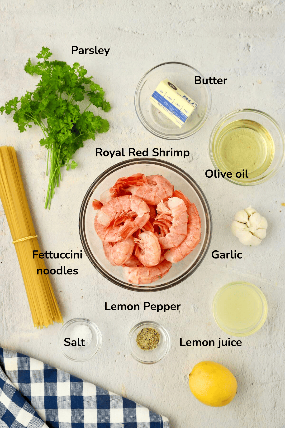 Ingredients for garlic butter noodles with shrimp, including shrimp, noodles, white wine, lemon juice and garlic.