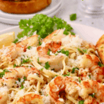 Garlic Butter Noodles with Shrimp on a plate topped with chopped parsley.