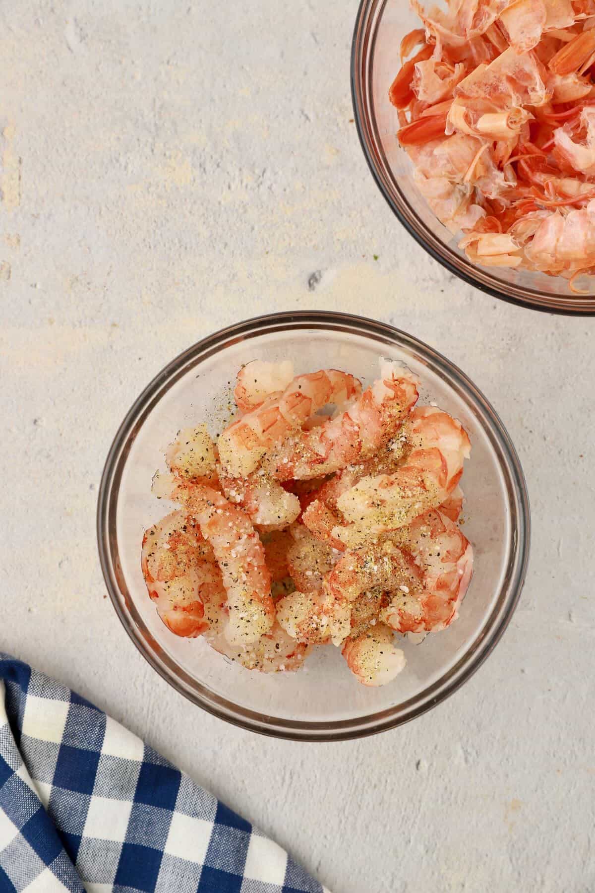 Royal red shrimp in a bowl seasoned with lemon pepper and salt.