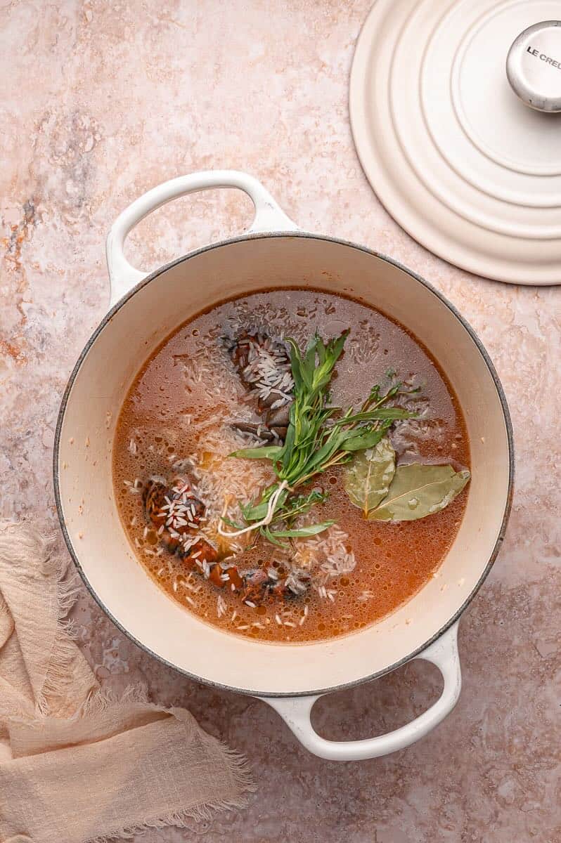 Rice, herbs, wine, and stock added to lobster bisque base.