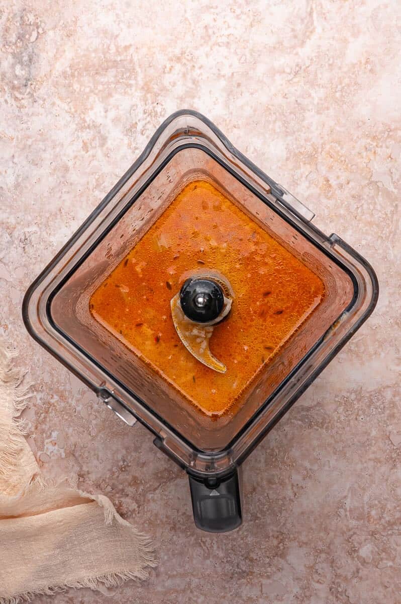 Blender jar with lobster bisque base added to blend.